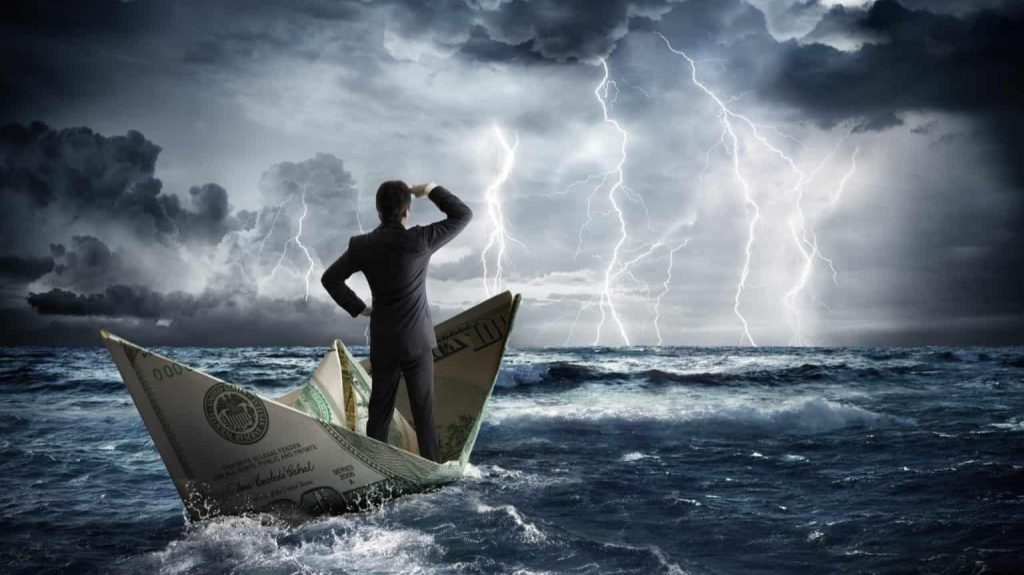 A businessman sailing a paper boat with money on the ocean, symbolizing financial risk and entrepreneurship.