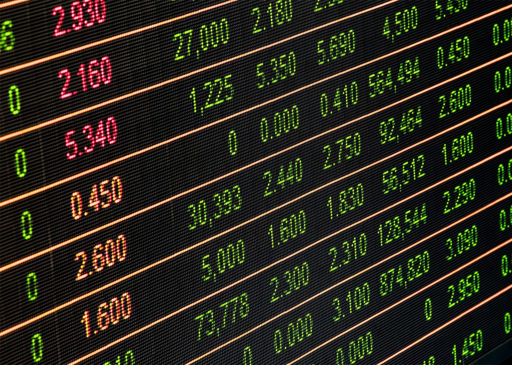 Financial data showing stock market quotes displayed on a digital screen.